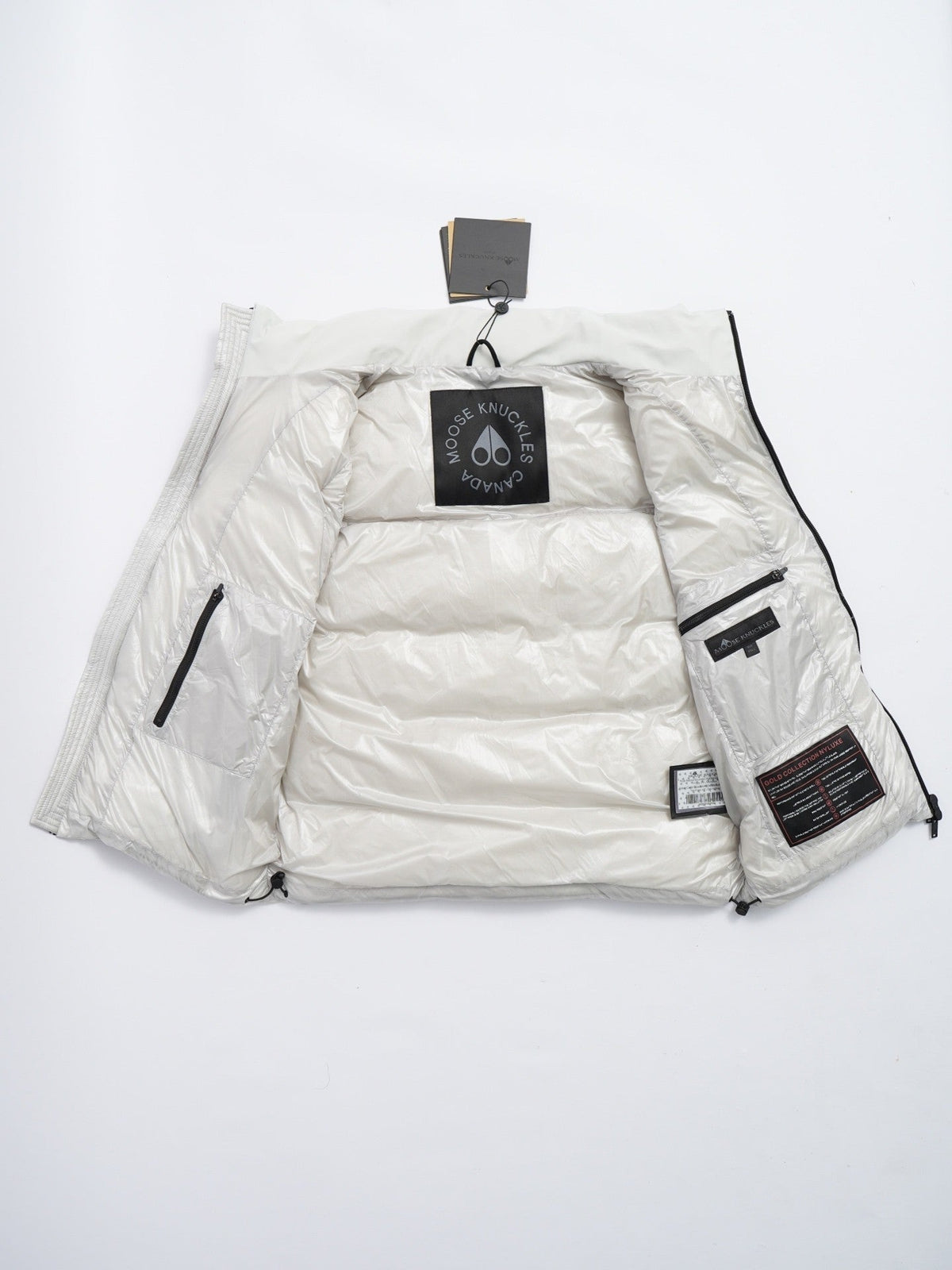 Moose Knuckles Puffer Vest in White with Stand Collar and Metallic Logo